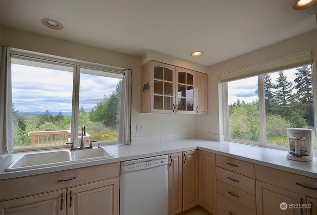 kitchen featuring dishwasher, light brown cabinetry, and sink