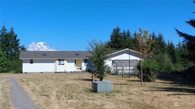 view of front of property featuring a sunroom and a front yard