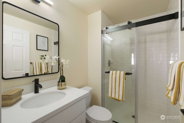 bathroom with an enclosed shower, toilet, and vanity