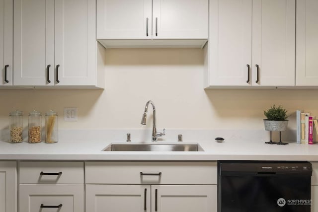 kitchen featuring sink, white cabinets, and dishwasher