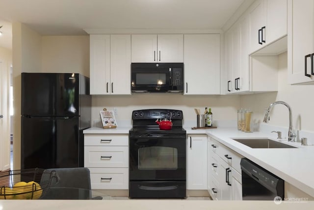 kitchen with white cabinetry, sink, and black appliances