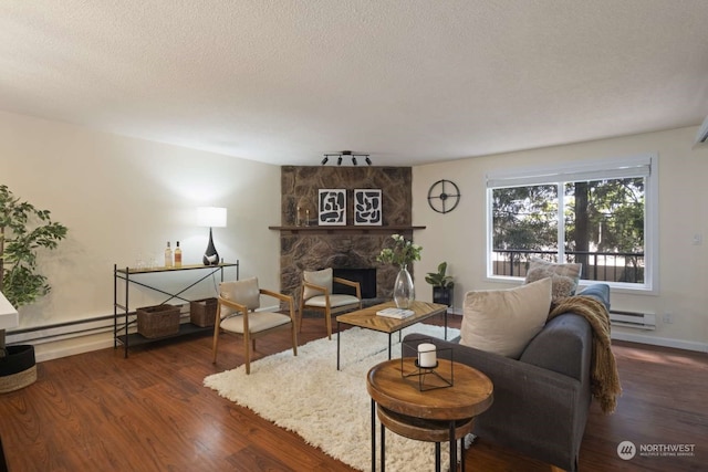 living room featuring a stone fireplace, dark hardwood / wood-style flooring, and a textured ceiling