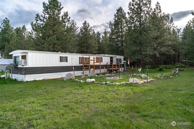 manufactured / mobile home with a deck and a front lawn