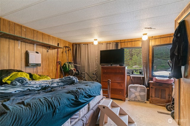 carpeted bedroom with wood walls