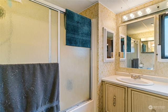 bathroom featuring shower / bath combination with glass door and large vanity