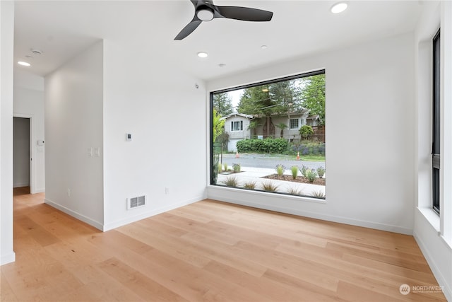 unfurnished room with ceiling fan and light hardwood / wood-style flooring