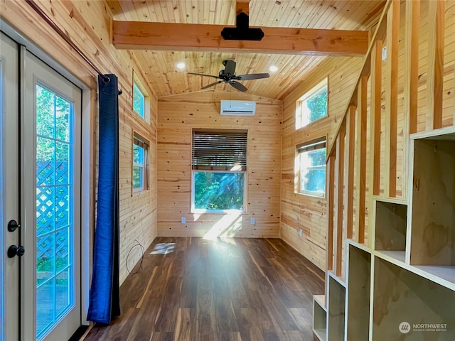 interior space featuring ceiling fan, hardwood / wood-style floors, wood ceiling, a wall unit AC, and wooden walls