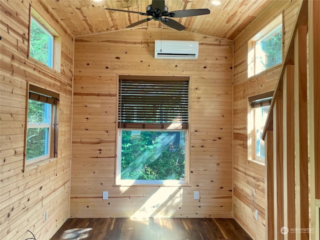 empty room featuring an AC wall unit, wooden walls, hardwood / wood-style flooring, and wood ceiling