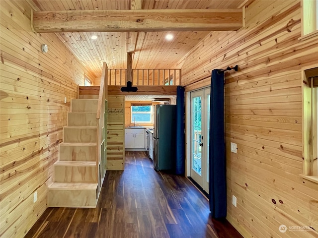 corridor with wooden ceiling, wooden walls, beamed ceiling, and hardwood / wood-style flooring