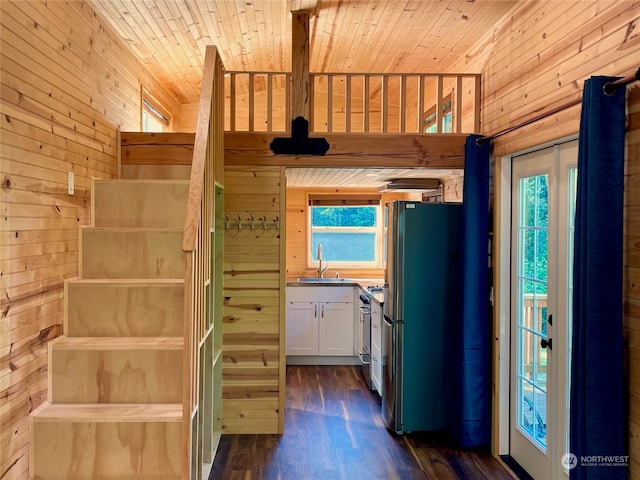 kitchen with wood ceiling, wooden walls, fridge, and dark hardwood / wood-style flooring