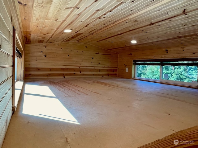 spare room with wooden walls, lofted ceiling, and wood ceiling