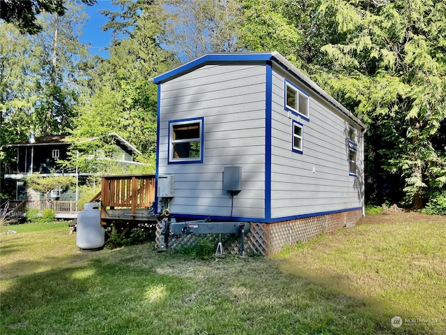 view of outdoor structure featuring a lawn