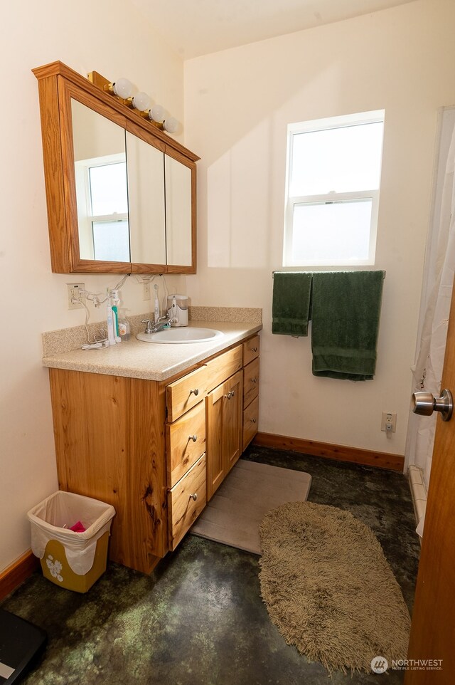 bathroom with vanity and concrete flooring