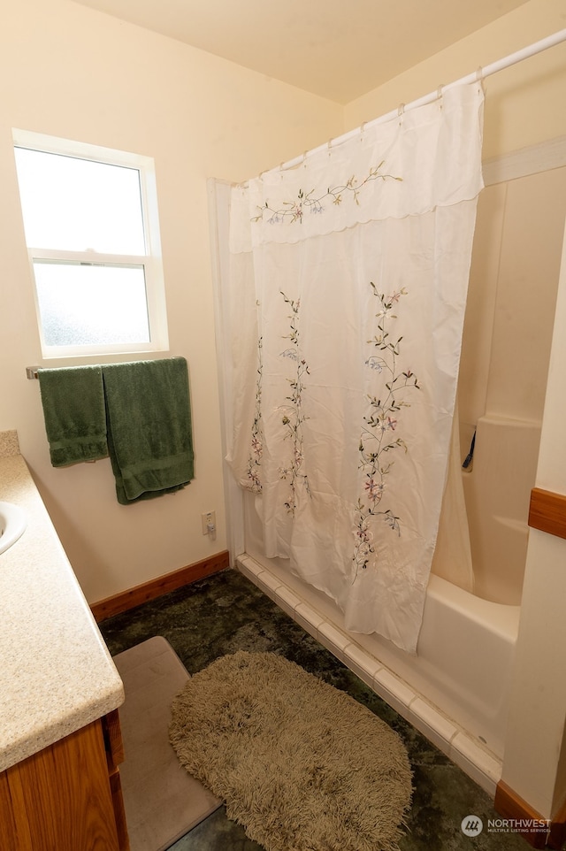 bathroom with shower / tub combo and vanity