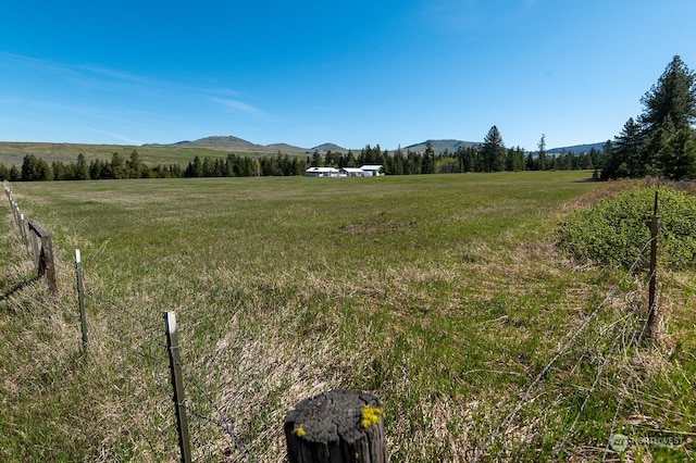 exterior space with a rural view and a mountain view