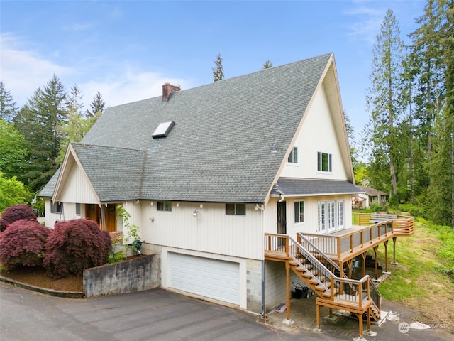 view of front of property with a garage and a deck