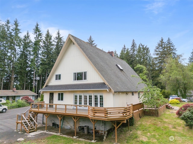 rear view of house featuring a wooden deck