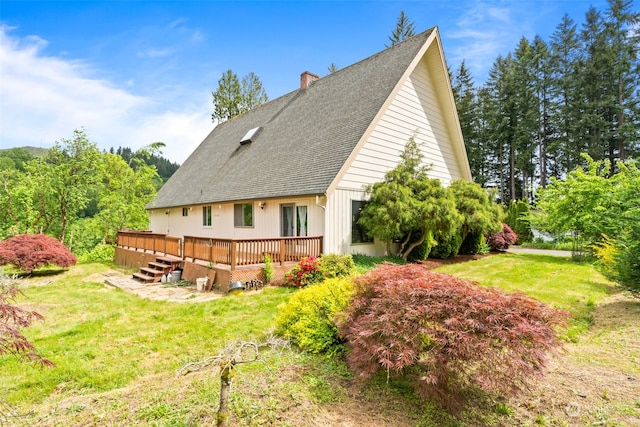 view of side of property featuring a deck and a yard