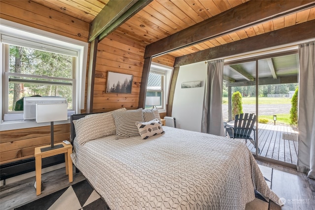 bedroom featuring access to exterior, wood walls, hardwood / wood-style floors, beam ceiling, and wood ceiling