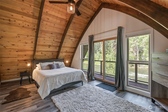 bedroom with dark wood-type flooring, lofted ceiling with beams, access to outside, wooden ceiling, and ceiling fan