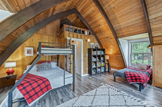 bedroom featuring lofted ceiling with beams, hardwood / wood-style flooring, and wood ceiling