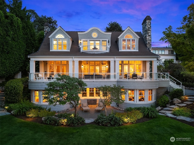 back house at dusk with a yard