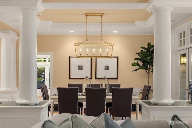 dining area with ornate columns and ornamental molding