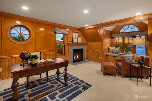 carpeted office featuring plenty of natural light, vaulted ceiling, and wood walls