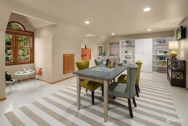 dining area with lofted ceiling and light carpet