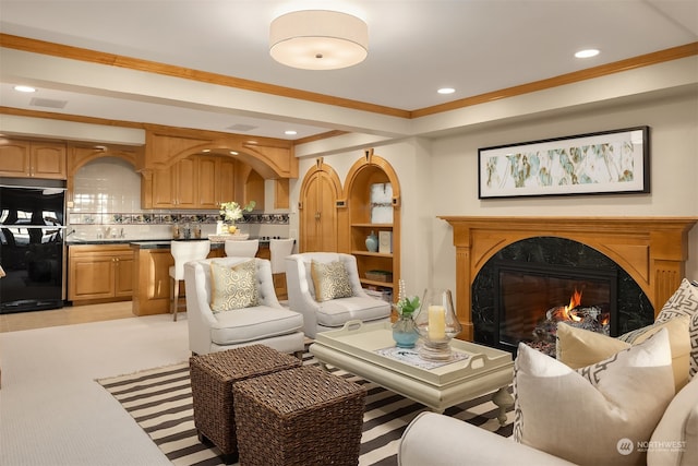 living room featuring a premium fireplace and ornamental molding