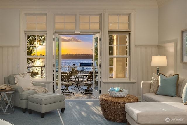 living area featuring carpet flooring and a water view