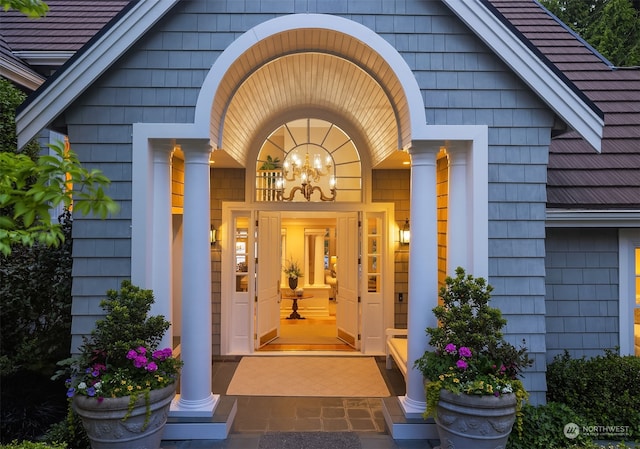 view of exterior entry featuring covered porch