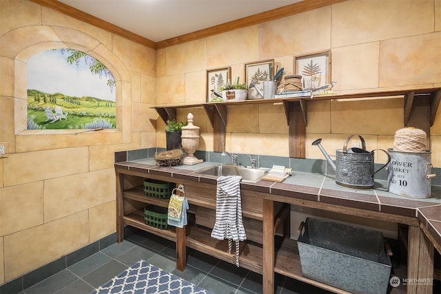 interior space featuring sink, tile walls, and crown molding