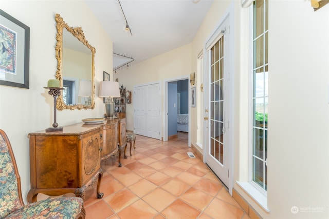 entrance foyer with french doors, track lighting, and light tile floors