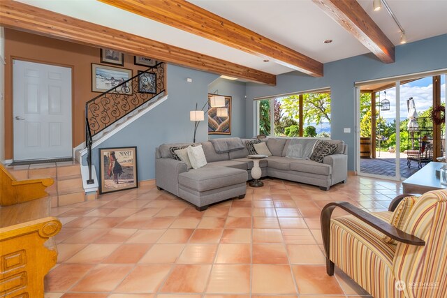 tiled living room with track lighting and beam ceiling