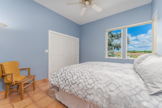 bedroom with a closet, ceiling fan, and tile floors