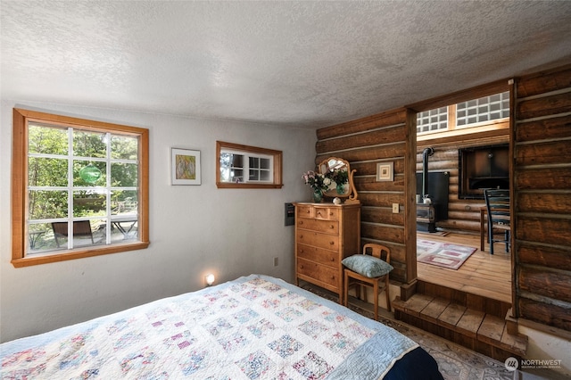 bedroom featuring vaulted ceiling, rustic walls, and a textured ceiling