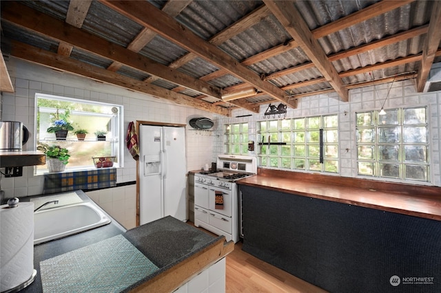 kitchen featuring coffered ceiling, tile walls, beamed ceiling, sink, and white appliances