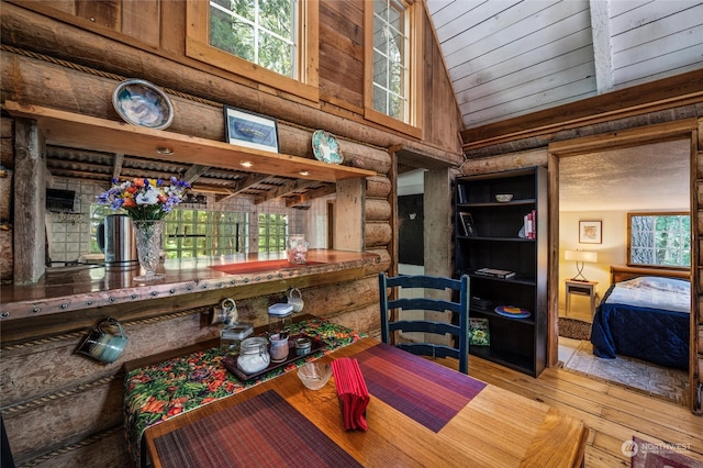 dining space featuring a wealth of natural light, high vaulted ceiling, and light wood-type flooring