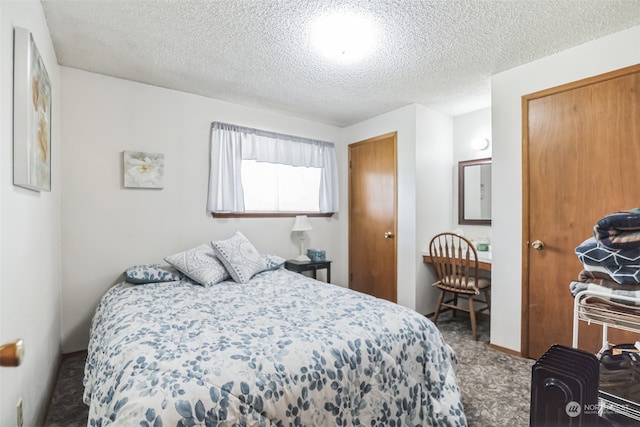 carpeted bedroom featuring a textured ceiling and a closet