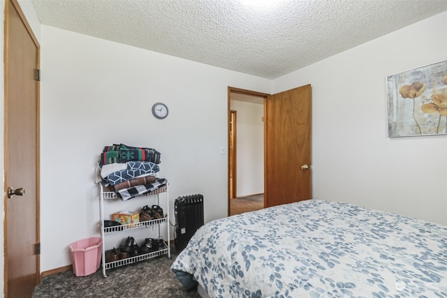 carpeted bedroom featuring a closet and a textured ceiling