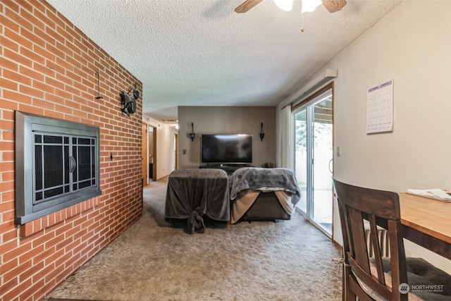 living room with brick wall, a textured ceiling, ceiling fan, and carpet floors