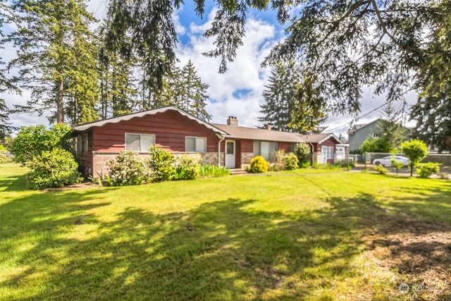 rear view of property with a yard