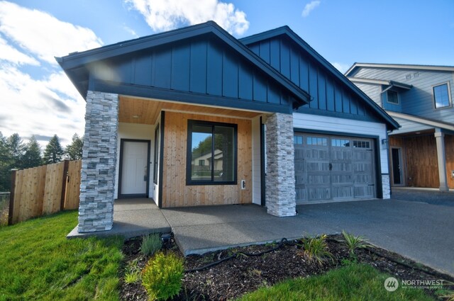 view of front of house featuring a garage and a front lawn