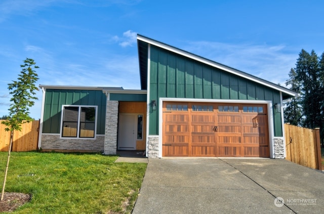 2122 Hawks View Ln, Winlock, WA 98596 - modern home with board and batten siding, stone siding, an attached garage, and concrete driveway