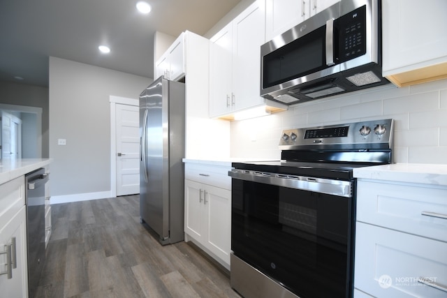 kitchen with backsplash, white cabinetry, dark hardwood / wood-style flooring, and stainless steel appliances