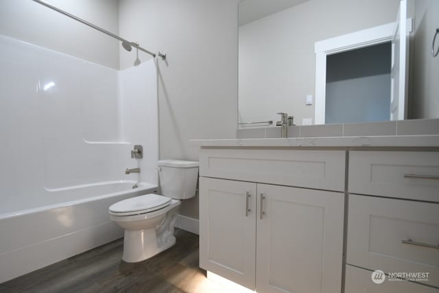 full bathroom with vanity, shower / bath combination, toilet, and hardwood / wood-style flooring