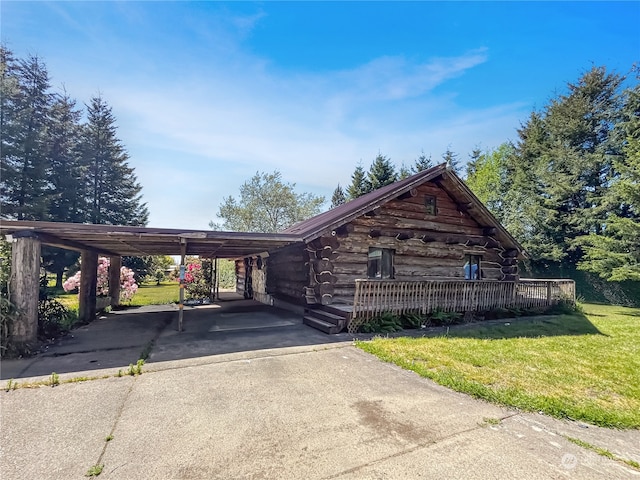 log-style house with a carport and a front yard