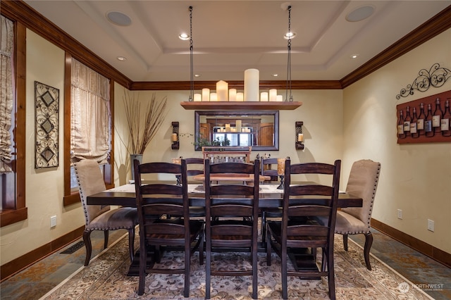 tiled dining space featuring crown molding and a raised ceiling