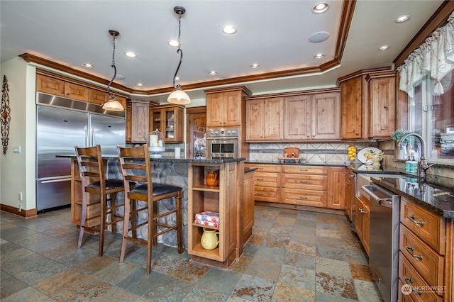 kitchen featuring dark tile patterned floors, a center island, tasteful backsplash, and stainless steel appliances